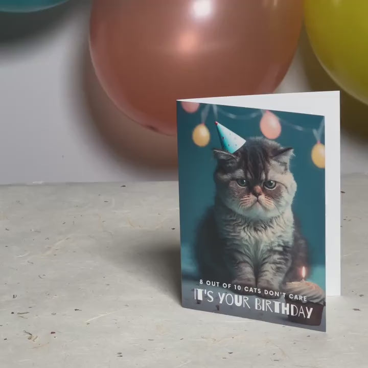 Augmented reality greeting card featuring a grumpy cat wearing a party hat against a background of party balloons